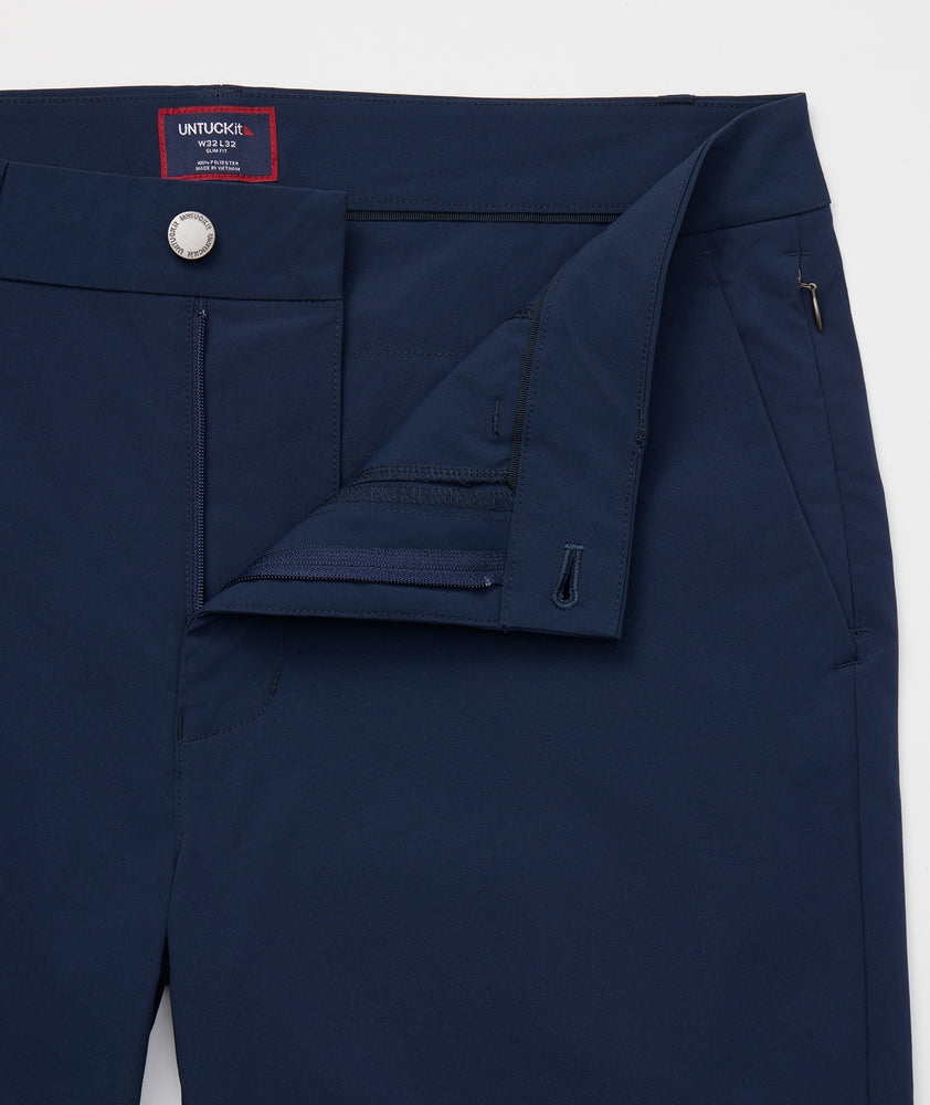 Model is wearing UNTUCKit Chancellor pants in navy. 