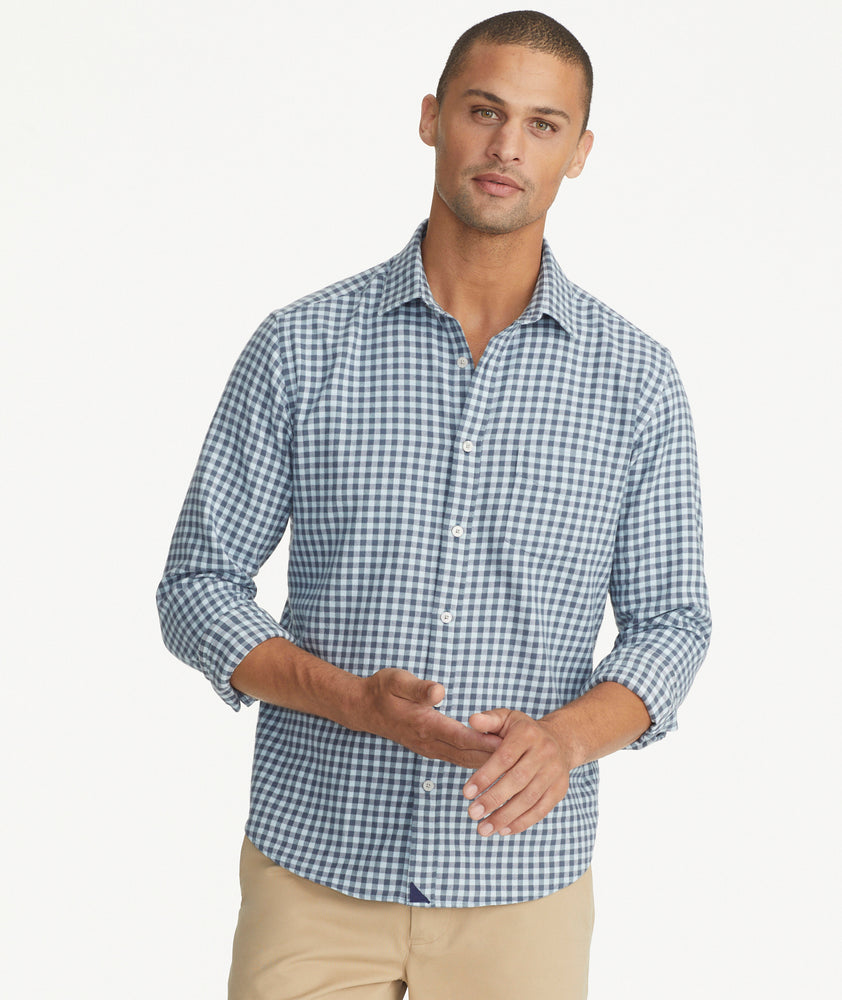 Model is wearing an UNTUCKit Alden gingham shirt in light blue.