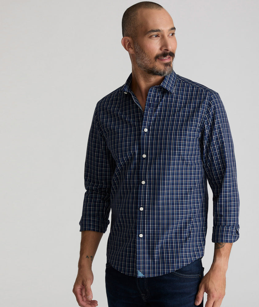 Model is wearing UNTUCKit Armstrong shirt in dark blue check.  