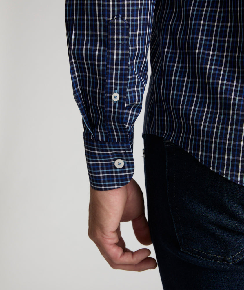 Model is wearing UNTUCKit Armstrong shirt in dark blue check.  