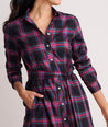 Model is wearing UNTUCKit Cassie dress in purple plaid. 