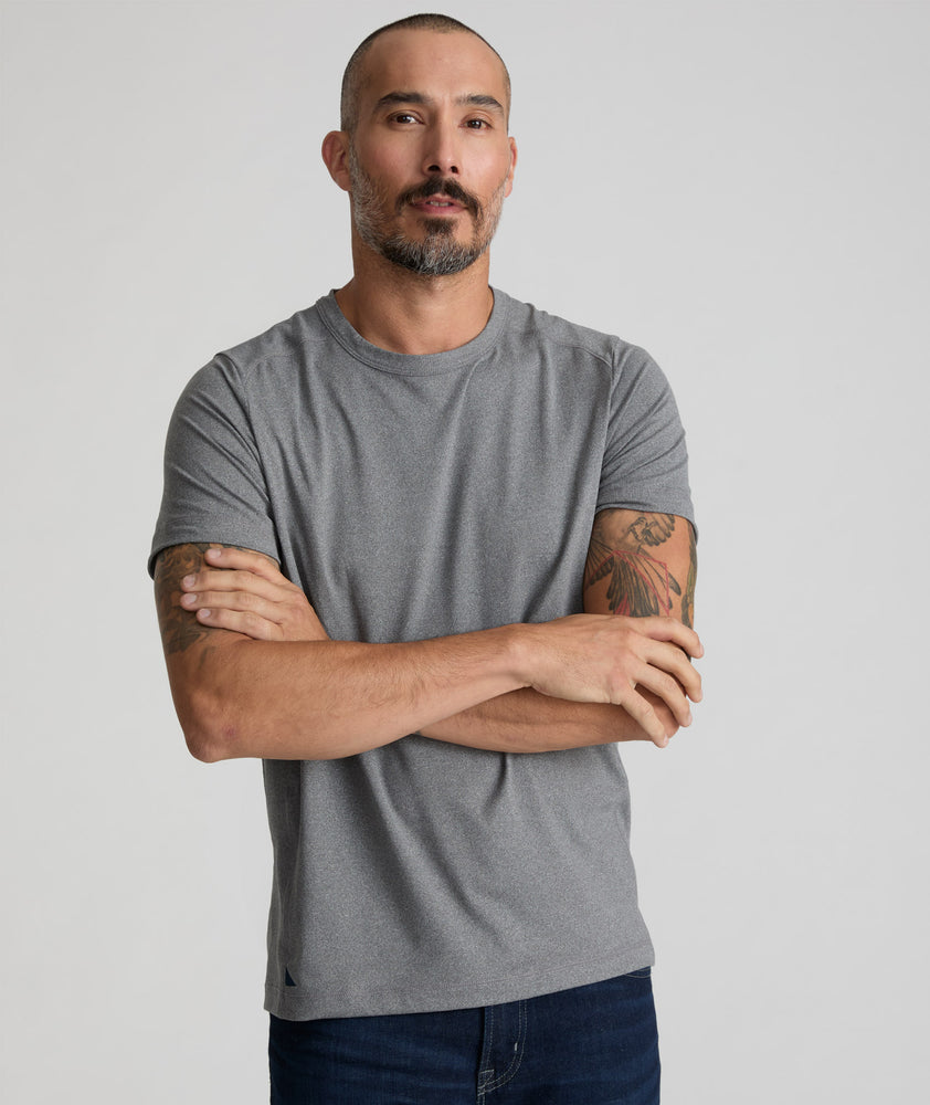 Model is wearing UNTUCKit Performance Tee in gray. 