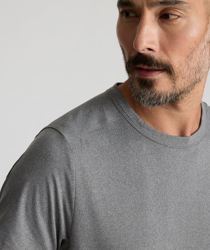 Model is wearing UNTUCKit Performance Tee in gray. 