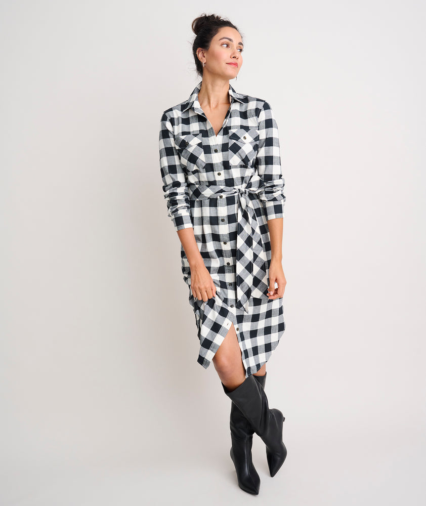 Model is wearing UNTUCKit Colby dress in black plaid.