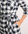 Model is wearing UNTUCKit Colby dress in black plaid.