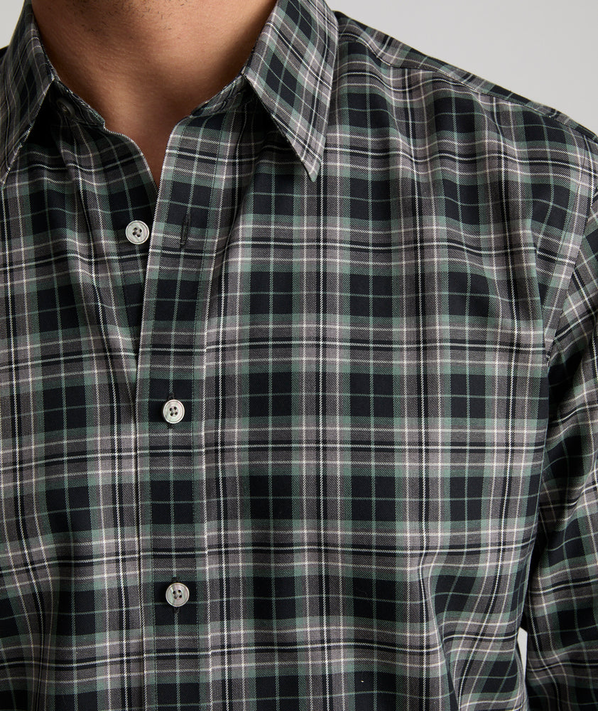 Model is wearing UNTUCKit Wrinkle-Free Devitt Shirt in Black Grounded Multi Plaid. 