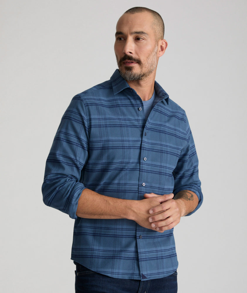 Model is wearing UNTUCKit Donnelly Shirt in blue grounded windowpane.