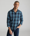 Model is wearing UNTUCKit Plaid Flannel Shirt in Navy & Light Blue Plaid | Fair Traide Certified™ . 