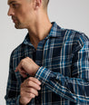 Model is wearing UNTUCKit Plaid Flannel Shirt in Navy & Light Blue Plaid | Fair Traide Certified™ . 