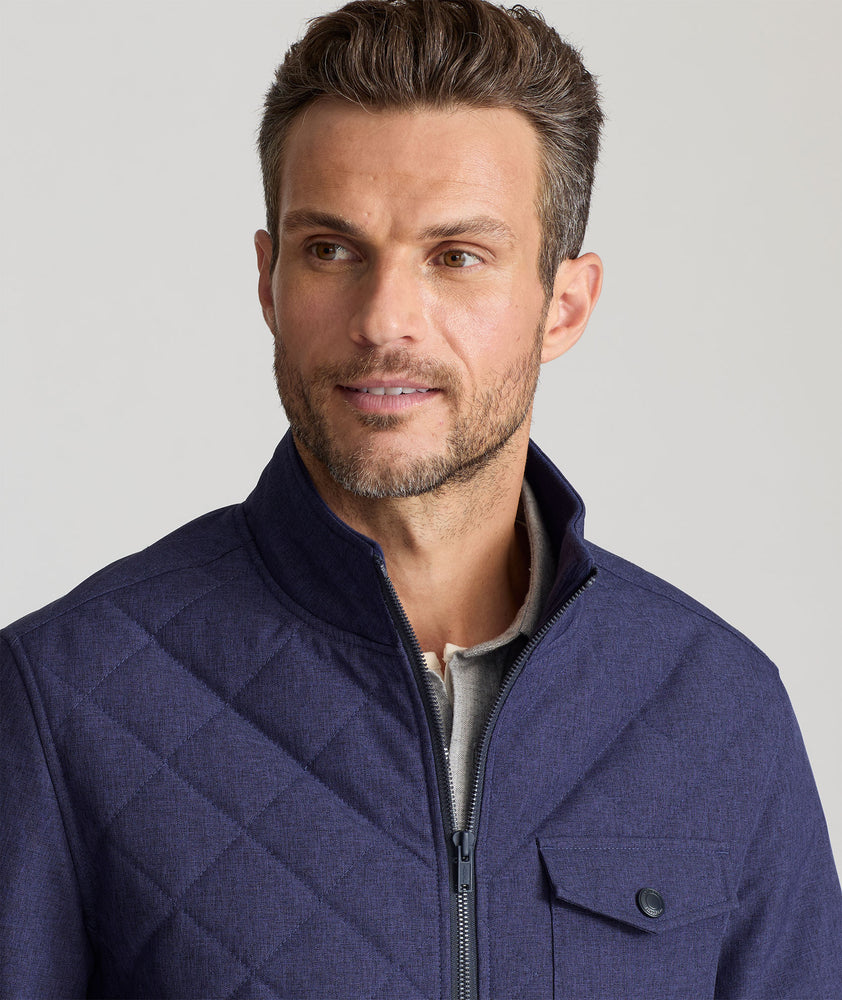 Model is wearing UNTUCKit Gardner quilted jacket in patriot blue.