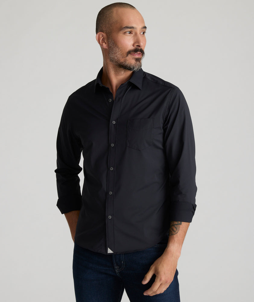 Model is wearing UNTUCKit gironde shirt in black. 