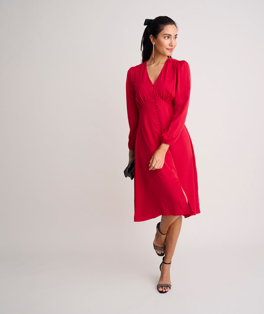 Model is wearing UNTUCKit Malorie dress in red. 