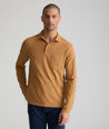 Model is wearing UNTUCKit long sleeve mays garment dyed polo in cathay spice.