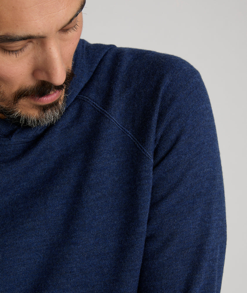 Model is wearing UNTUCKit Merino Hoodie in solid twilight blue. 