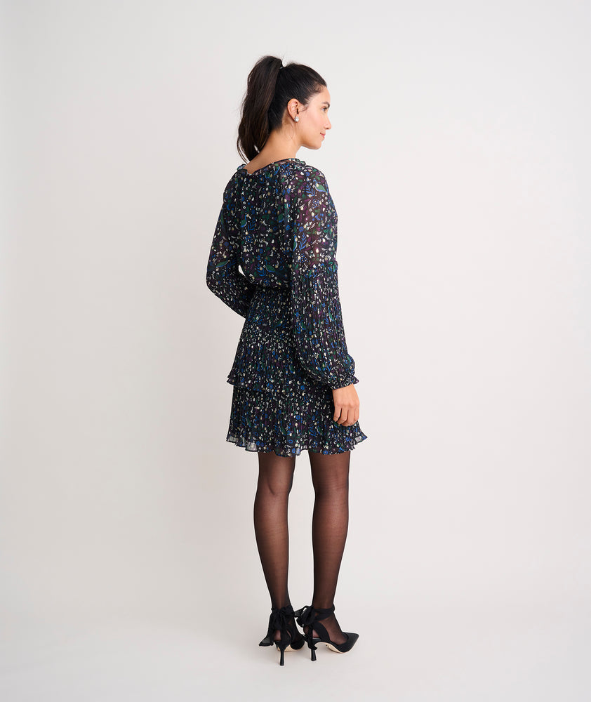 Model is wearing UNTUCKit Paloma dress in black print. 