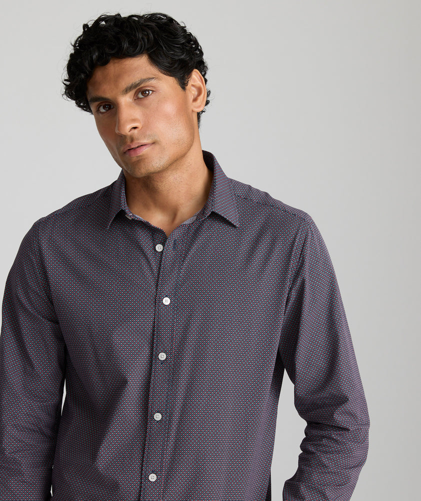 Model is wearing UNTUCKit Wrinkle-Free Performance Peraldi Shirt in Navy & Red Micro Print.