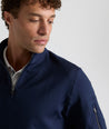 Model is wearing UNTUCKit performance sweatshirt in navy.