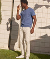 Model is wearing UNTUCKit Classic Chino Pants in Stone Gray.