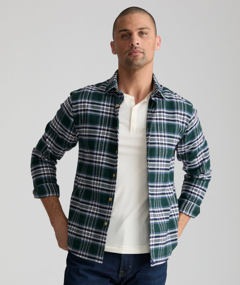 Model is wearing UNTUCKit Ray flannel in green in navy and white plaid.