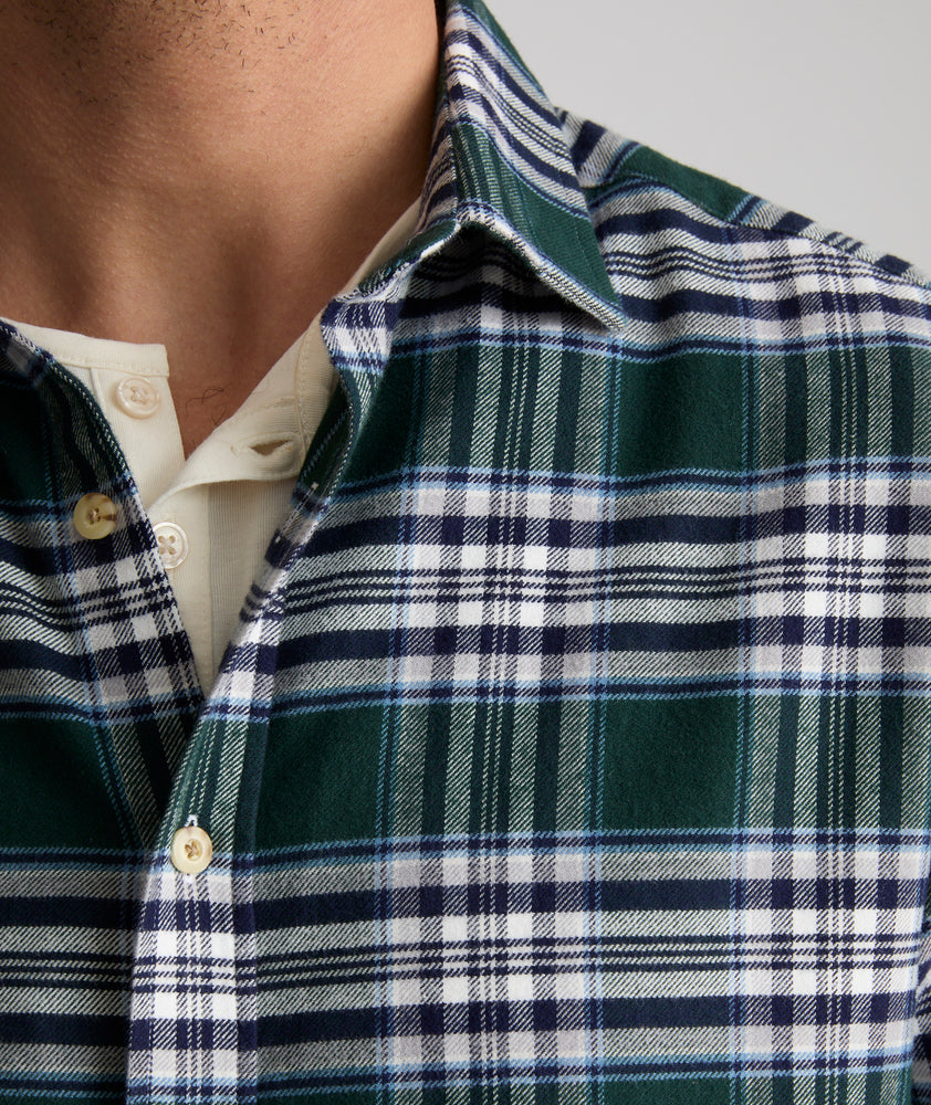 Model is wearing UNTUCKit Ray flannel in green in navy and white plaid.