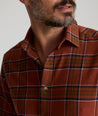 Model is wearing UNTUCKit Flannel Regner Shirt in Burnt Red Plaid.