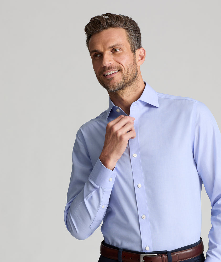 Model is wearing UNTUCKit Spencer shirt in blue. 