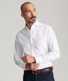 Model is wearing UNTUCKit Spencer shirt in white. 