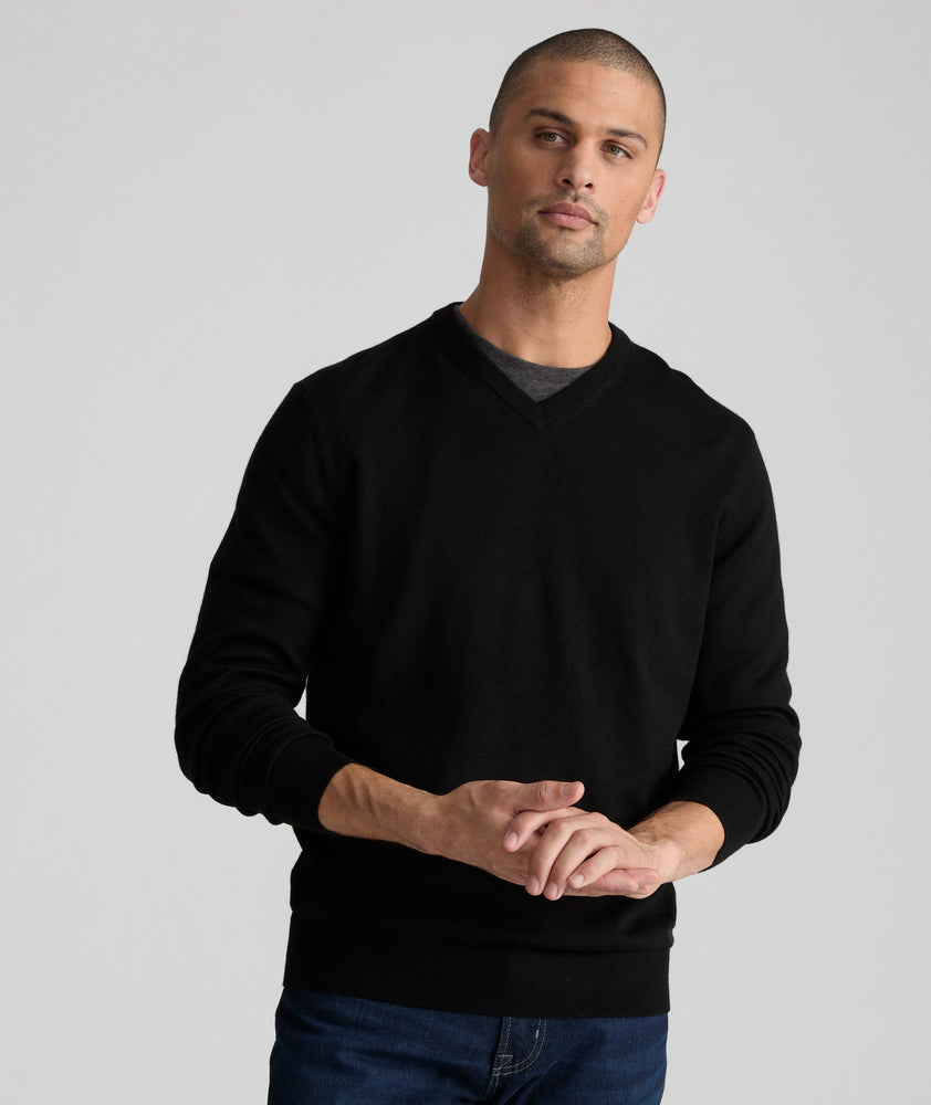 Model is wearing UNTUCKit sweater in black.