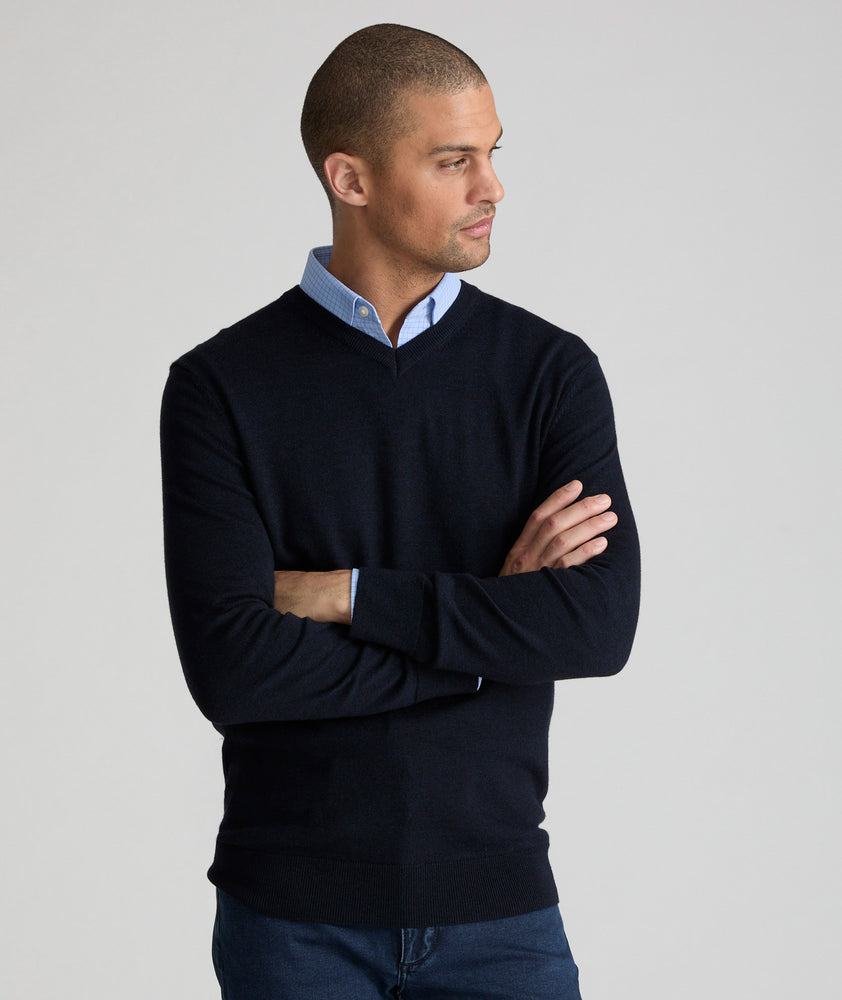 Model is wearing UNTUCKit sweater in navy.