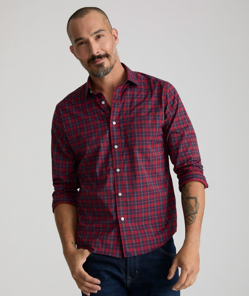 Model is wearing UNTUCKit Stevenson in red and Navy Plaid. 