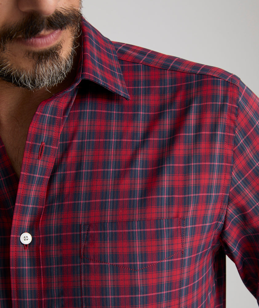 Model is wearing UNTUCKit Stevenson in red and Navy Plaid. 