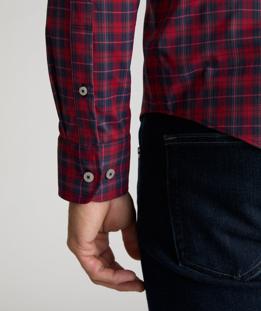 Model is wearing UNTUCKit Stevenson in red and Navy Plaid. 