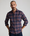 Model is wearing UNTUCKit Wrinkle-Free Performance Flannel Trezari Shirt in Navy Red & White Plaid.