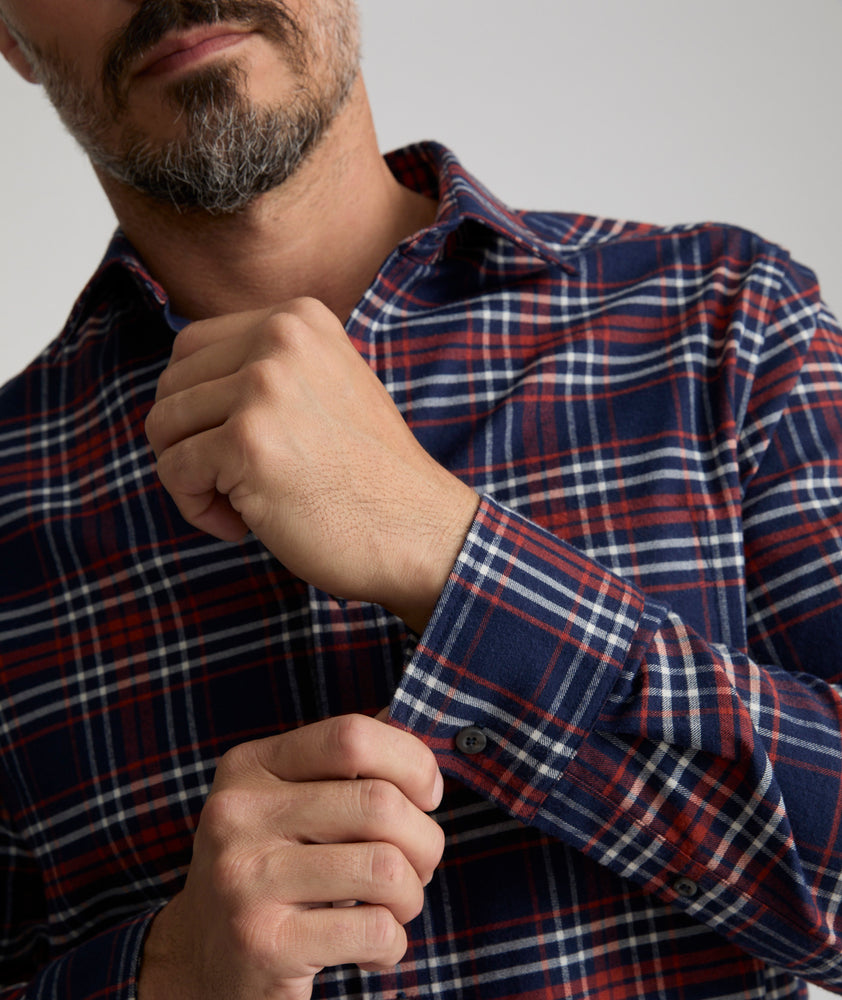 Model is wearing UNTUCKit Wrinkle-Free Performance Flannel Trezari Shirt in Navy Red & White Plaid.