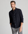 Model is wearing UNTUCKit Wrinkle-Free Veneto Shirt in black.