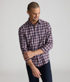 Model is wearing UNTUCKit Watkins shirt in grey, red and navy check. 