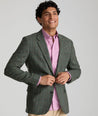 Model is wearing UNTUCKit Italian Wool Windsteig Sport Coat in Olive & Multicolor Windowpane.